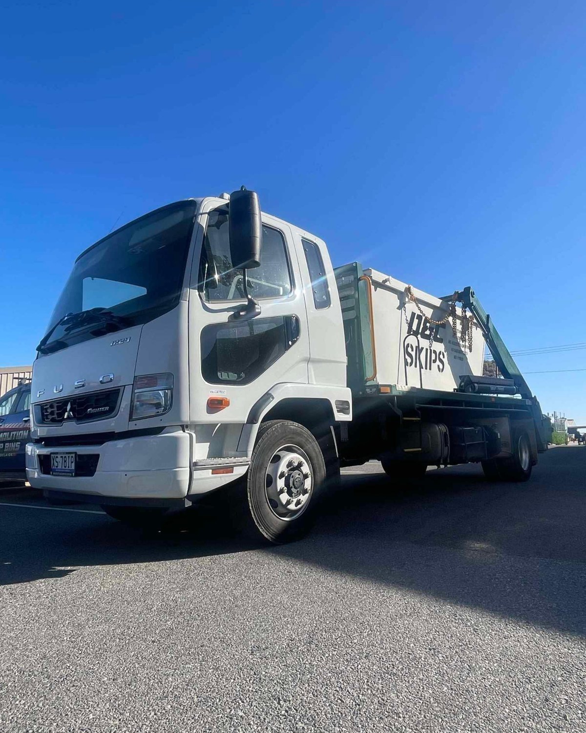D&C Skips truck with branded blue bins ready for delivery